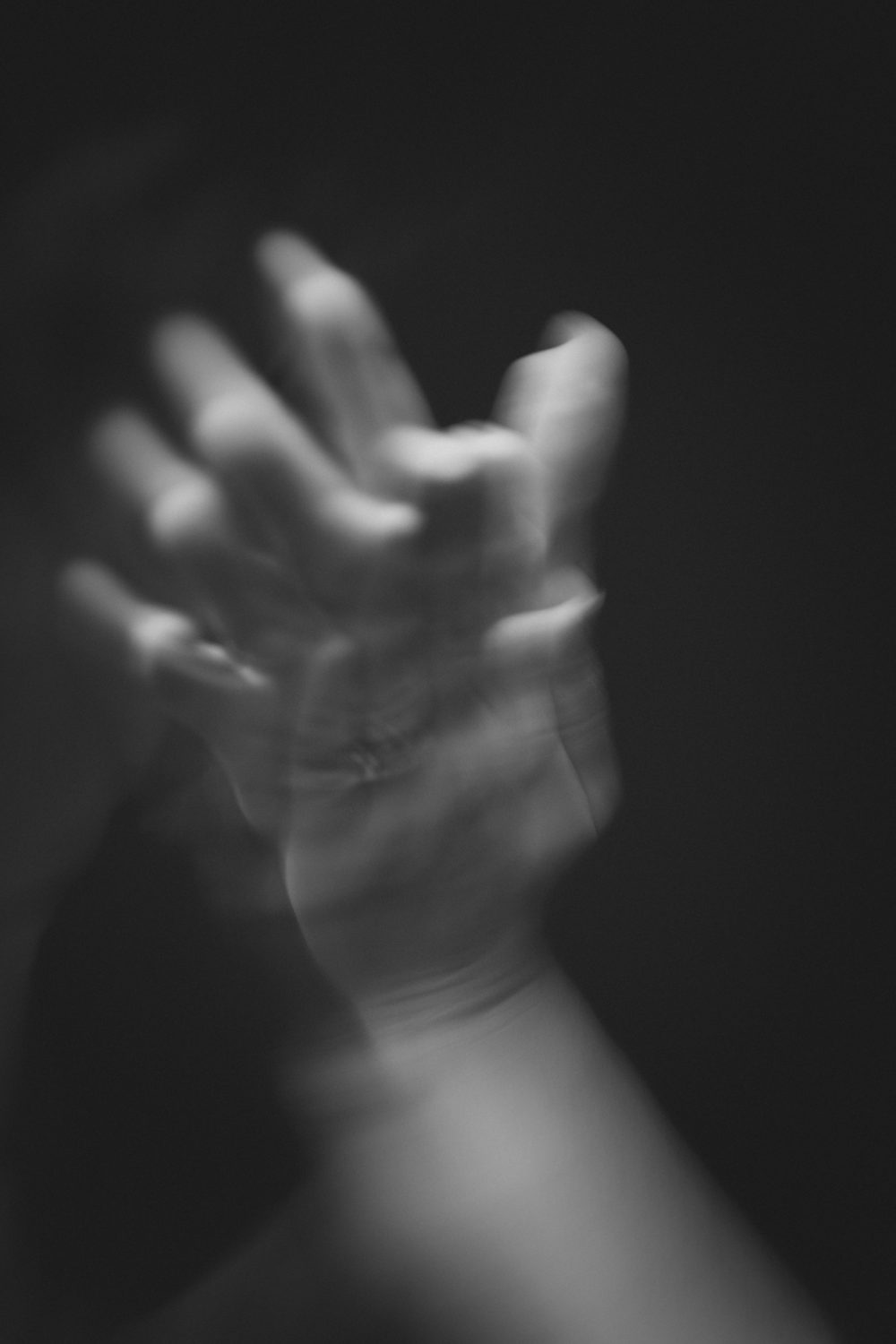 A reaching hand caught in soft light